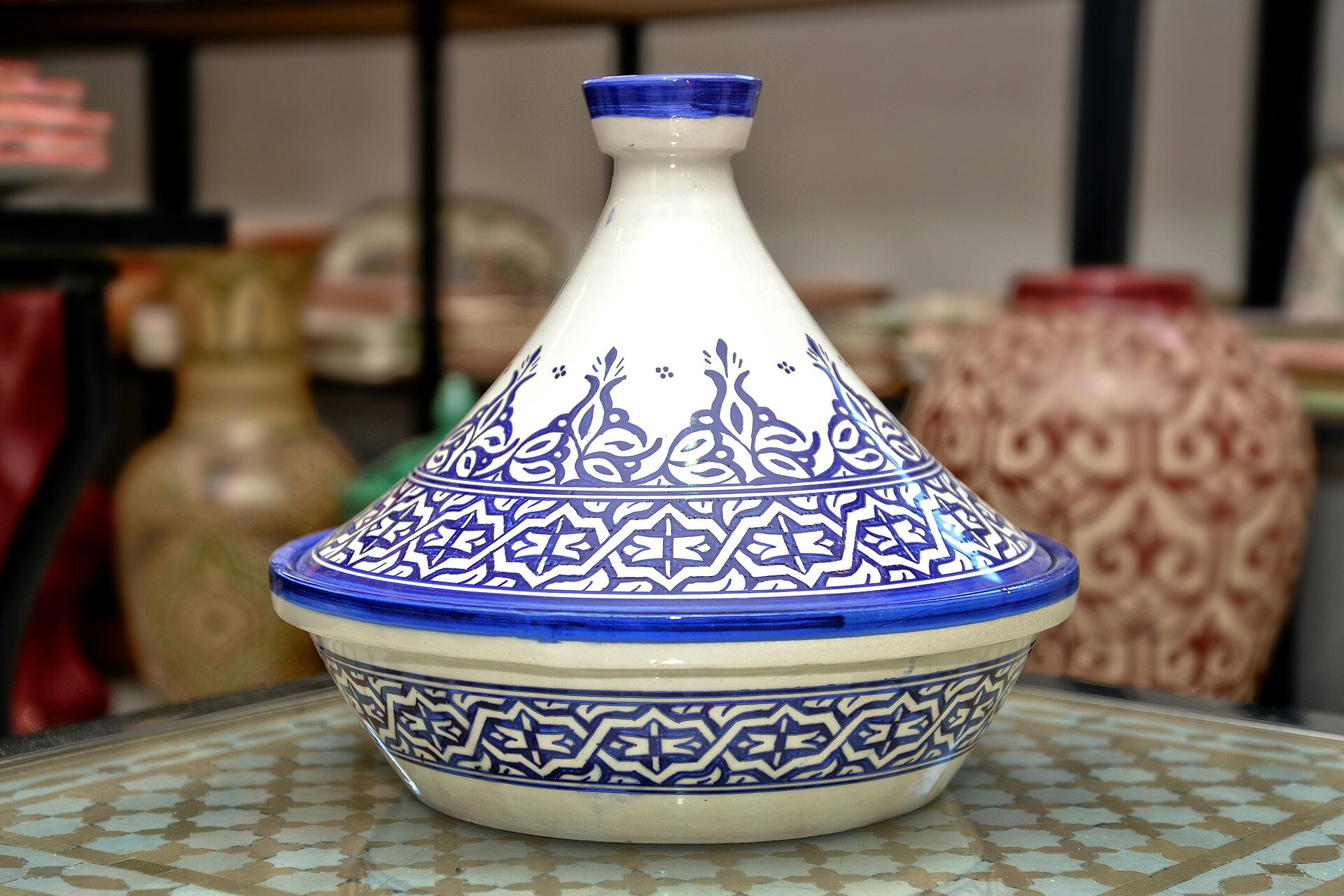 Traditional Moroccan tagine cooking vessel with blue patterns