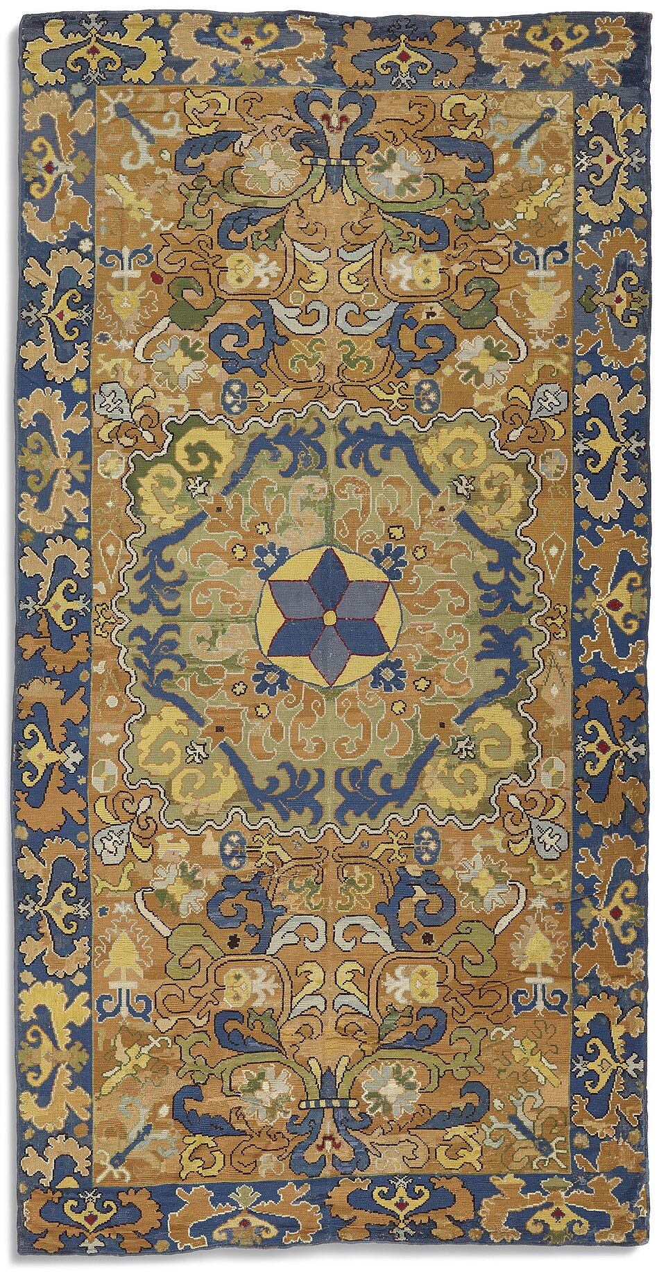 An eighteenth-century Arraiolos needlework rug with a blue, ochre and green floral pattern