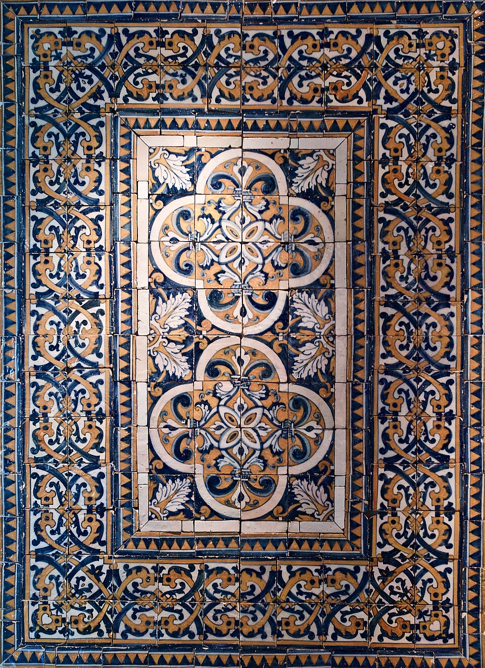 Blue, ochre and white patterned azulejos arranged as a carpet panel