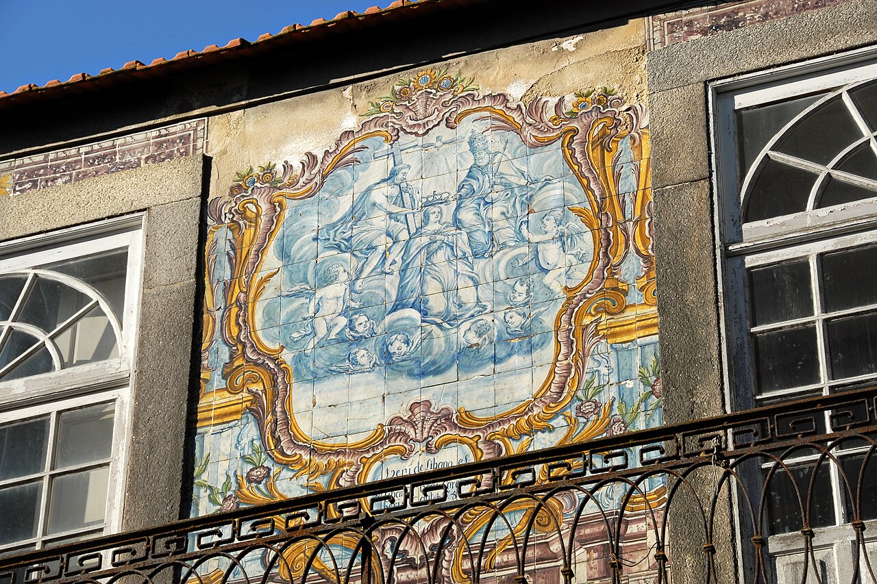 A framed blue-and-white azulejo panel on a house in Porto
