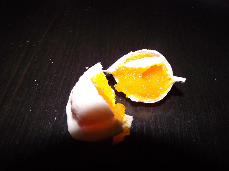 An Aveiro ovos moles sweet opened to show its egg-yolk filling