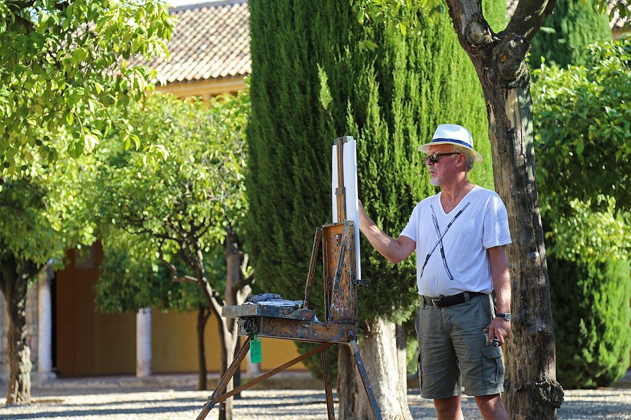 Artist Gerard Byrne painting outdoors in the Patio de los Naranjos in Córdoba